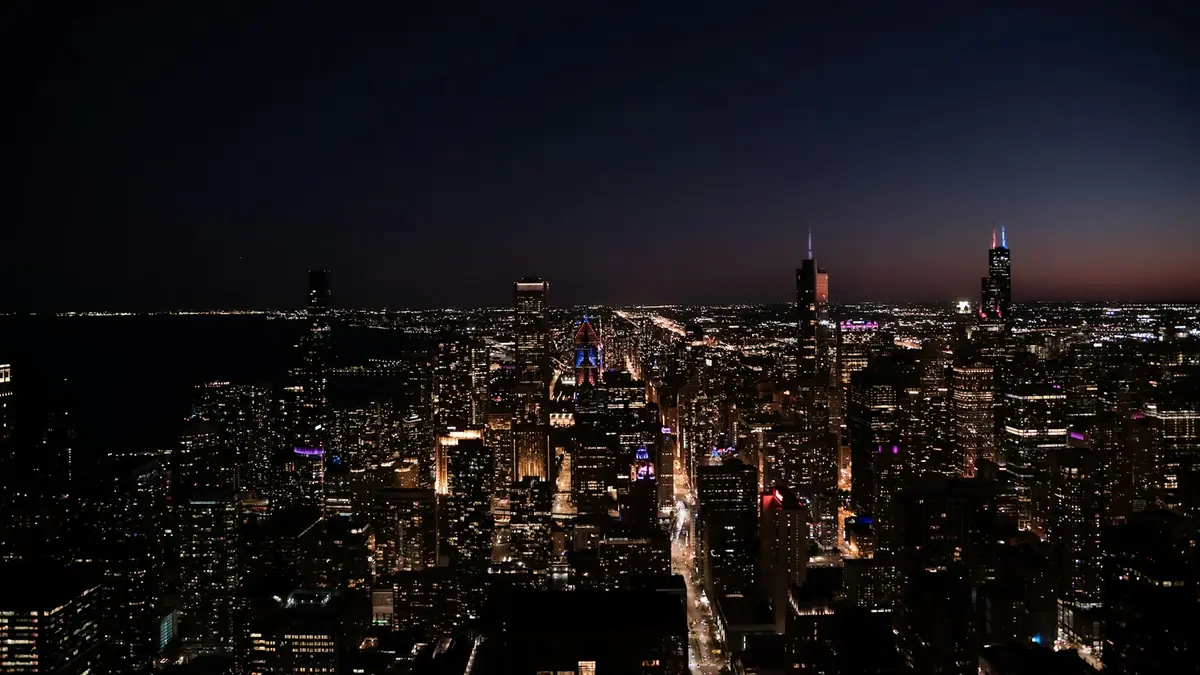 Chicago skyline glowing at night, seen from above